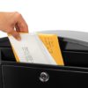 Open black wall mount mailbox with mail inside
