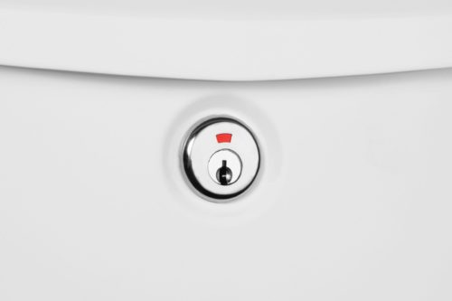 Zoomed in image of silver lock on white wall mount mailbox