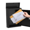 Open black wall mount mailbox with mail inside