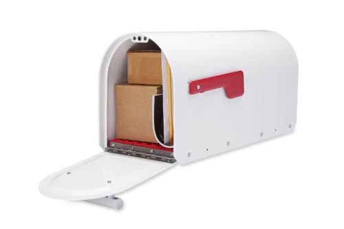 Open white mailbox with packages and mail inside