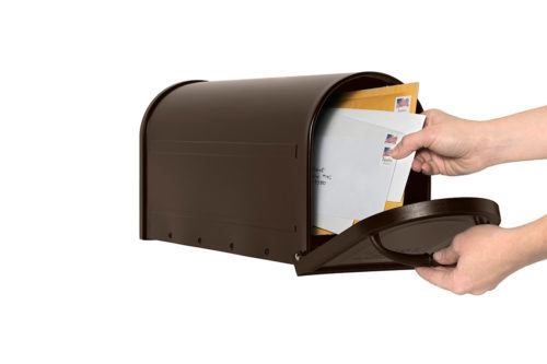 Open bronze mailbox with mail being delivered inside