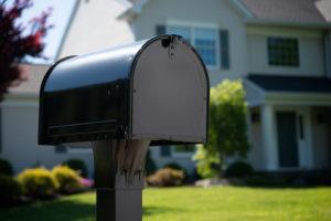 close-up of black mailbox installed on front lawn