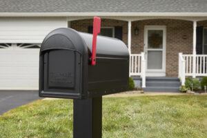 Black mailbox with a red flag raised