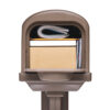 Zoomed in image of brown mailbox with mail inside
