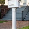 Decorative background of white post mount mailbox