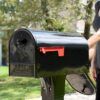 Decorative Background of Post Mount Mailbox with an Individual Reaching to Grab Mail