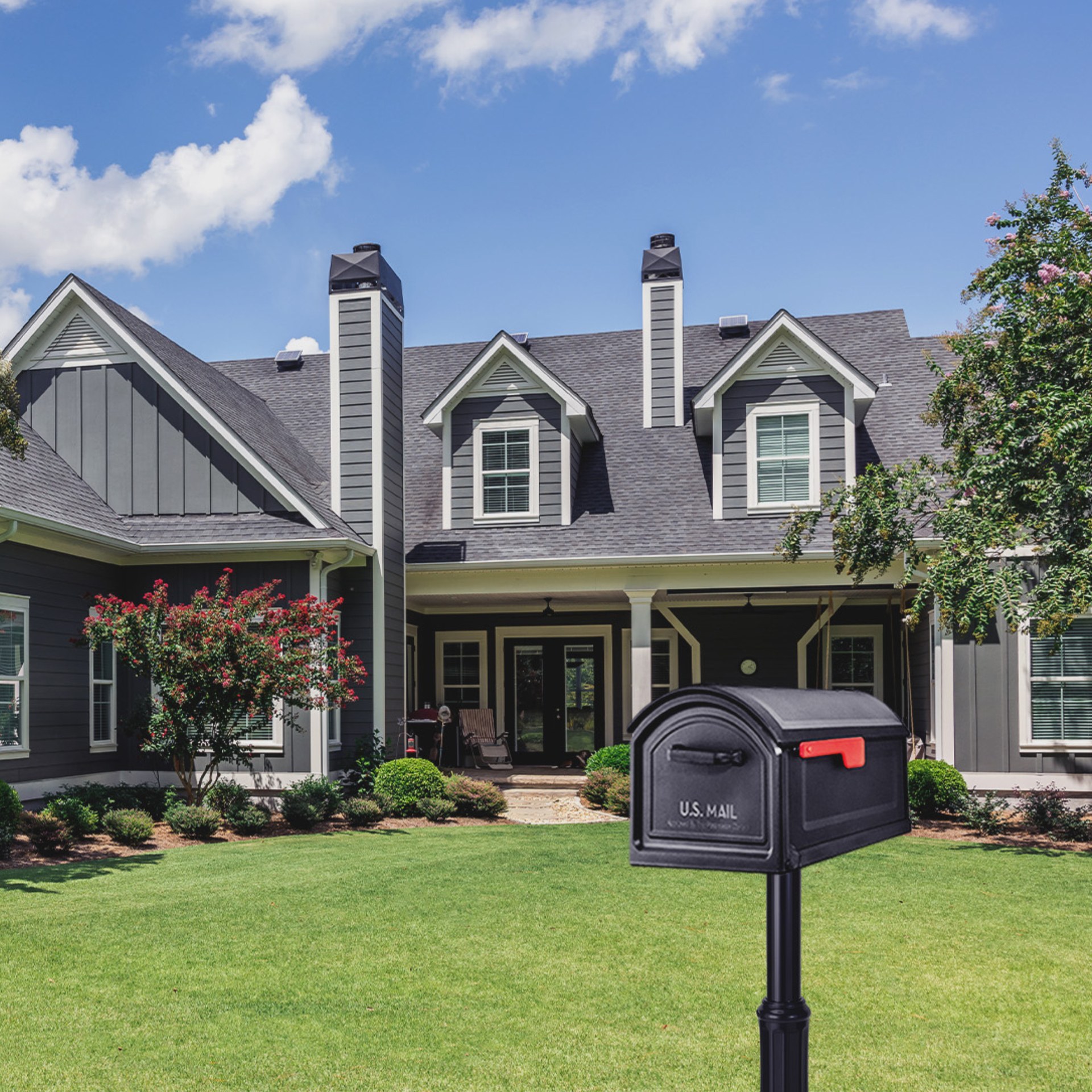 BILT CRE8 Mailbox installed in front of grey house