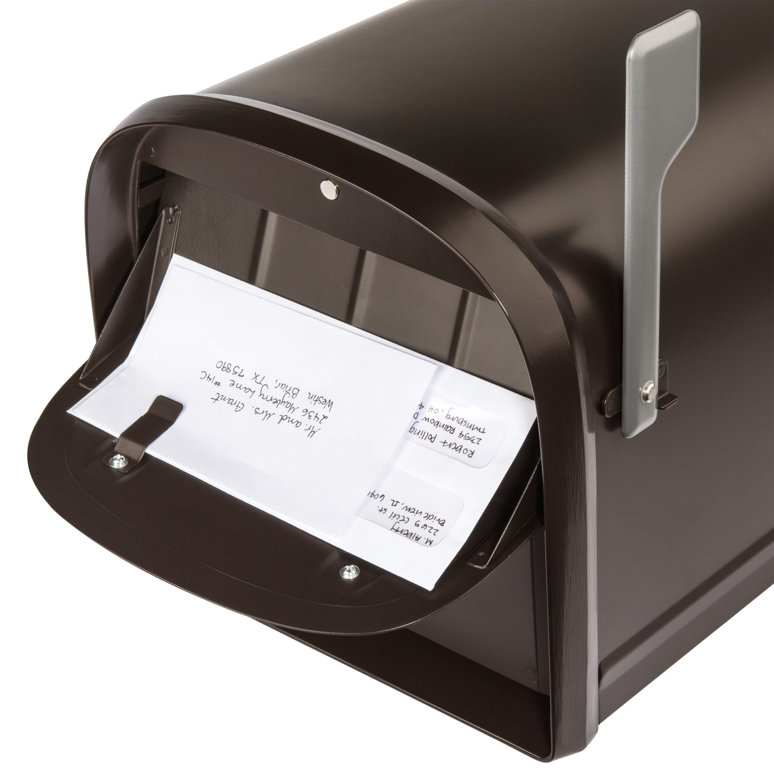Brown metal mailbox with a white envelope halfway inserted into the mail slot