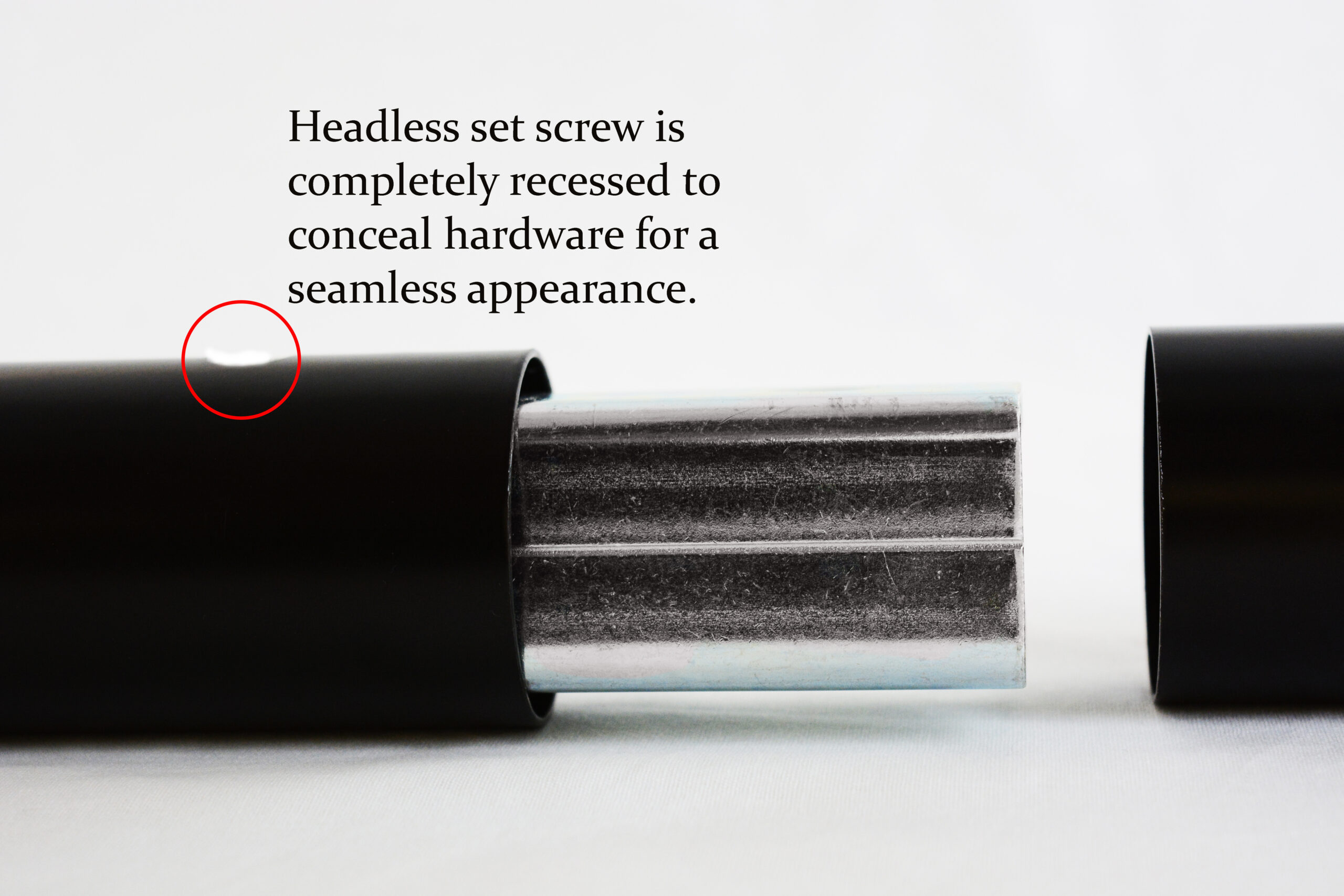Close-up of a black cylindrical component with a recessed headless set screw to conceal hardware for a seamless appearance.
