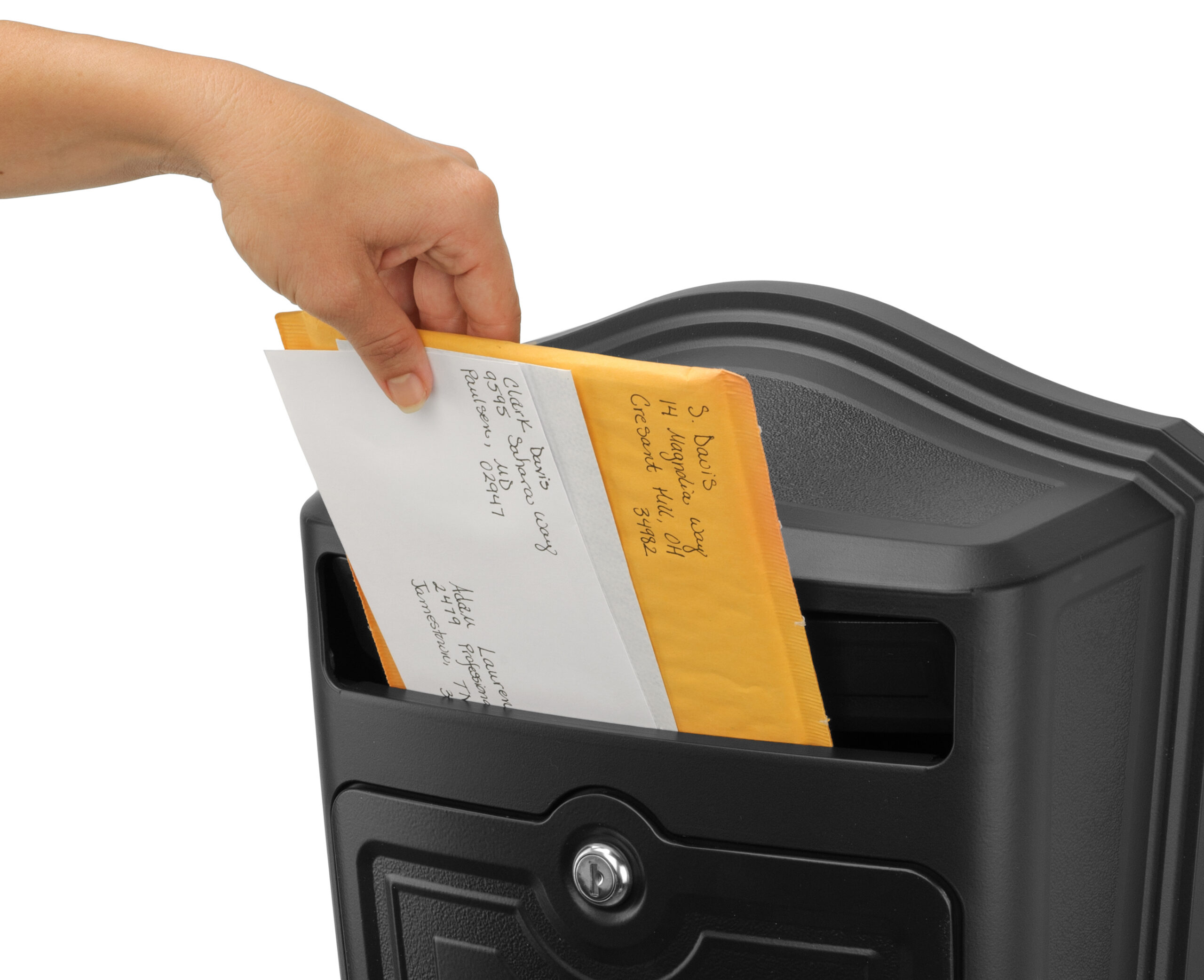 Person's hand inserts envelopes into a black mailbox slot, sending letters.