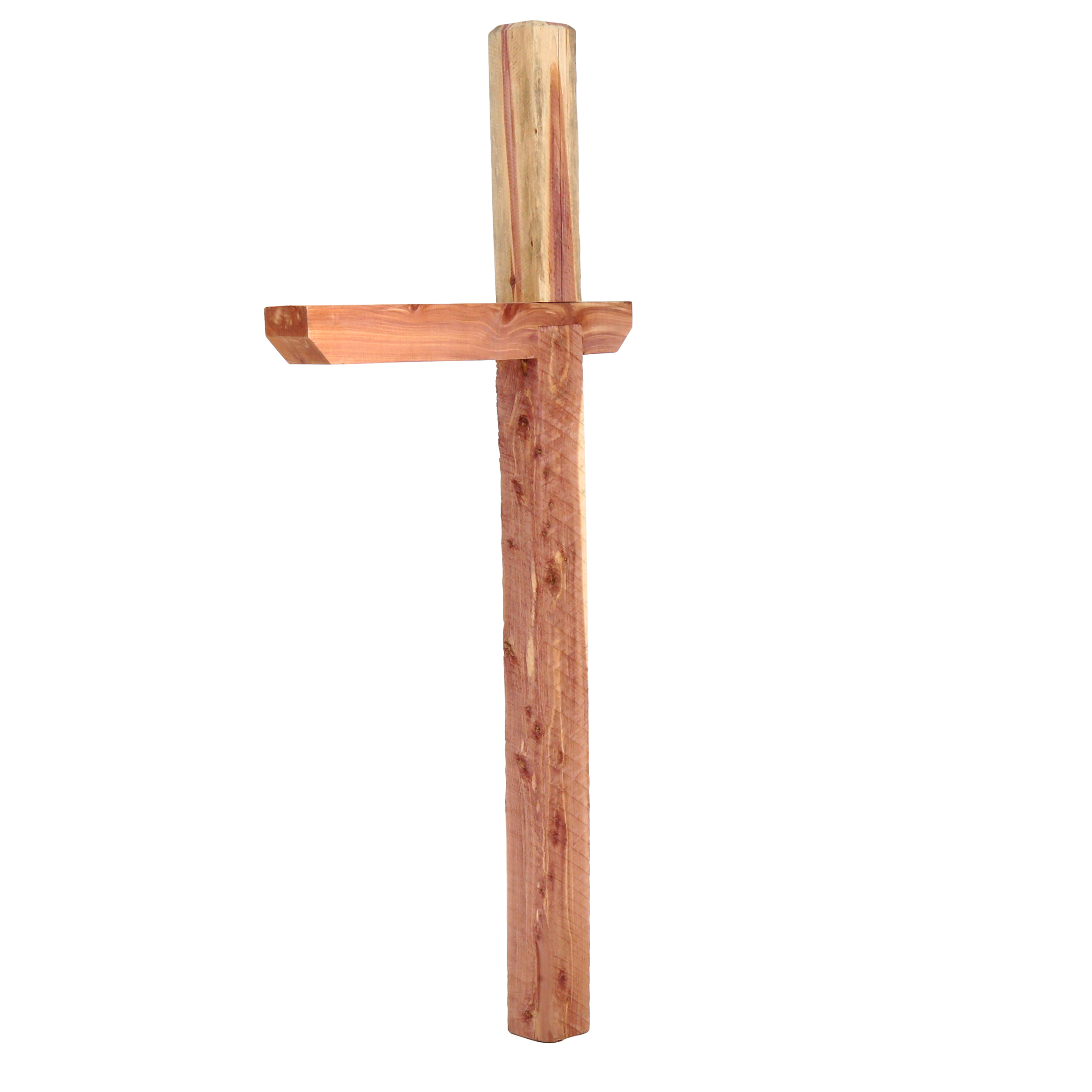 Rough-hewn wooden cross made from vertical and horizontal logs, simple and natural in finish, set against a plain background.