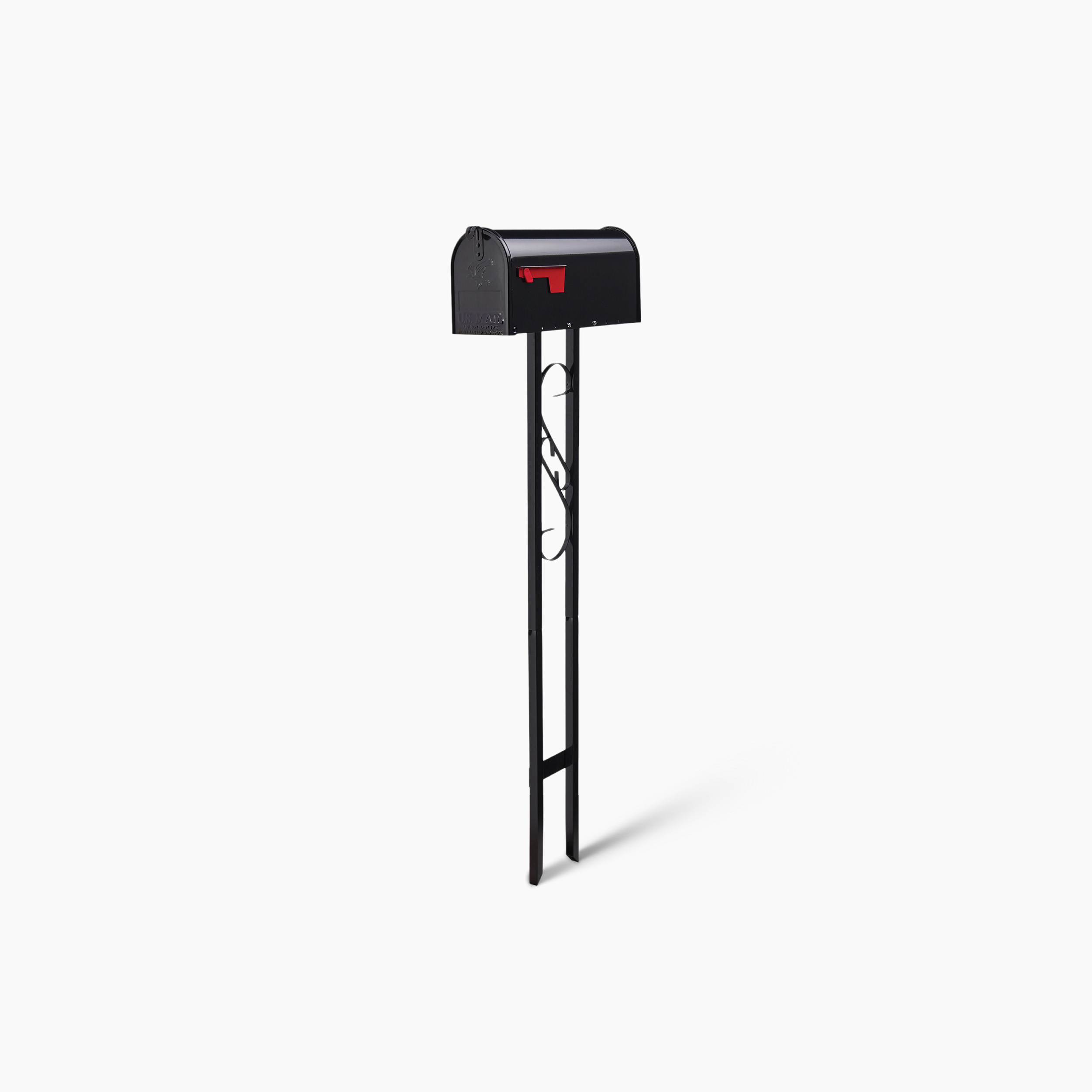 Black mailbox on a tall black metal stand with a red flag.