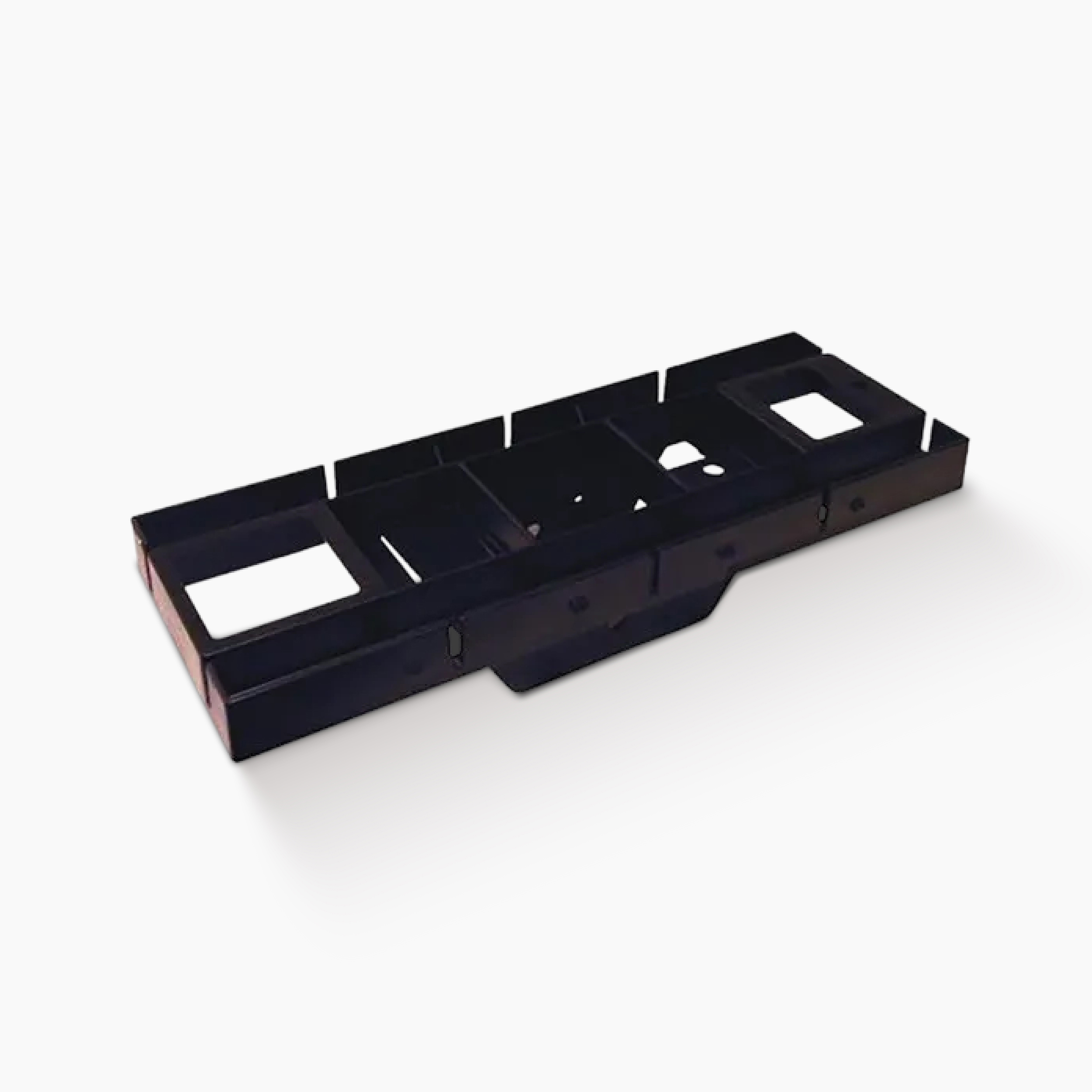 Long black plastic tray with multiple rectangular compartments, likely a vehicle interior console part.