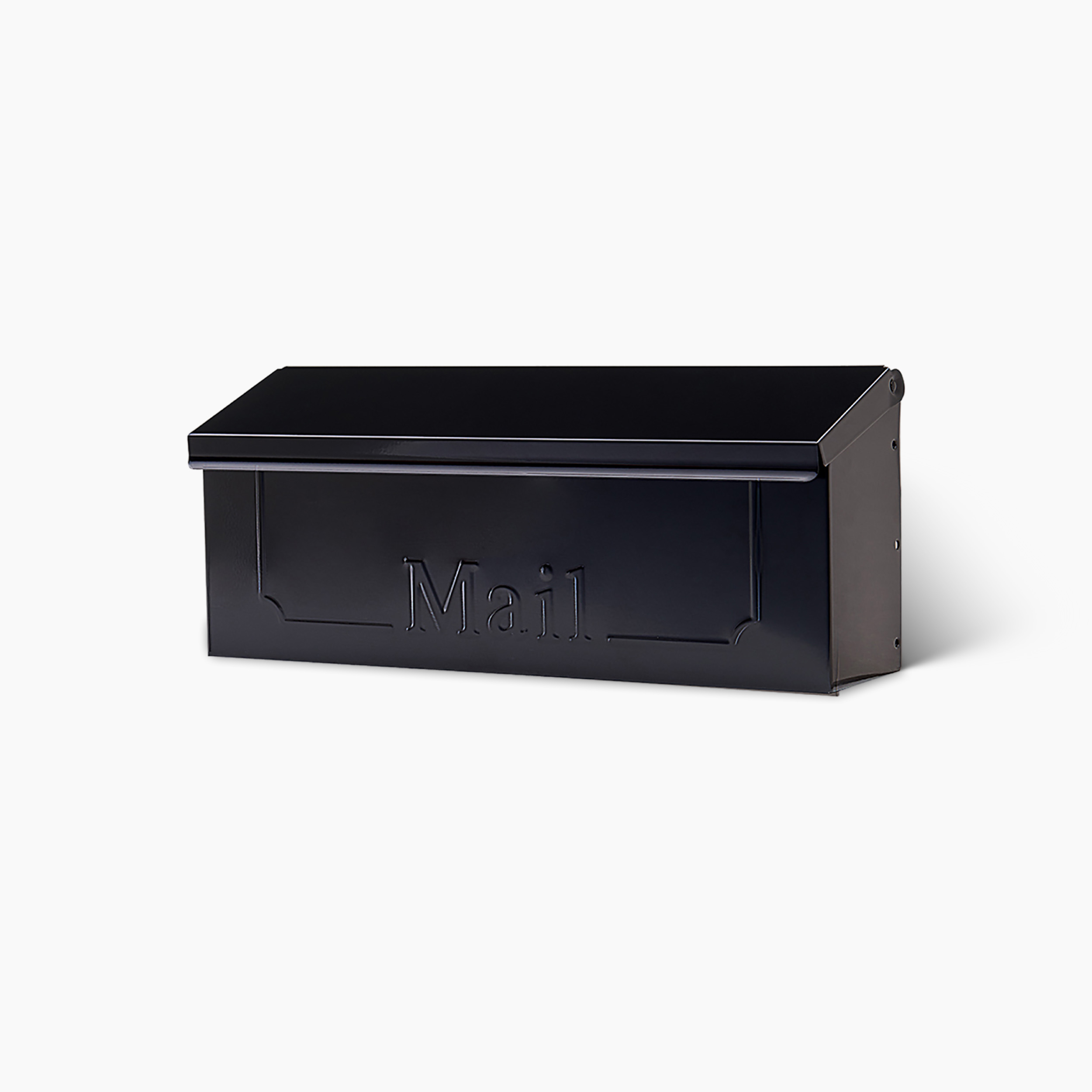 Black metal curbside mailbox with a hinged lid and the word 'Mail' embossed on the front surface, empty and closed.