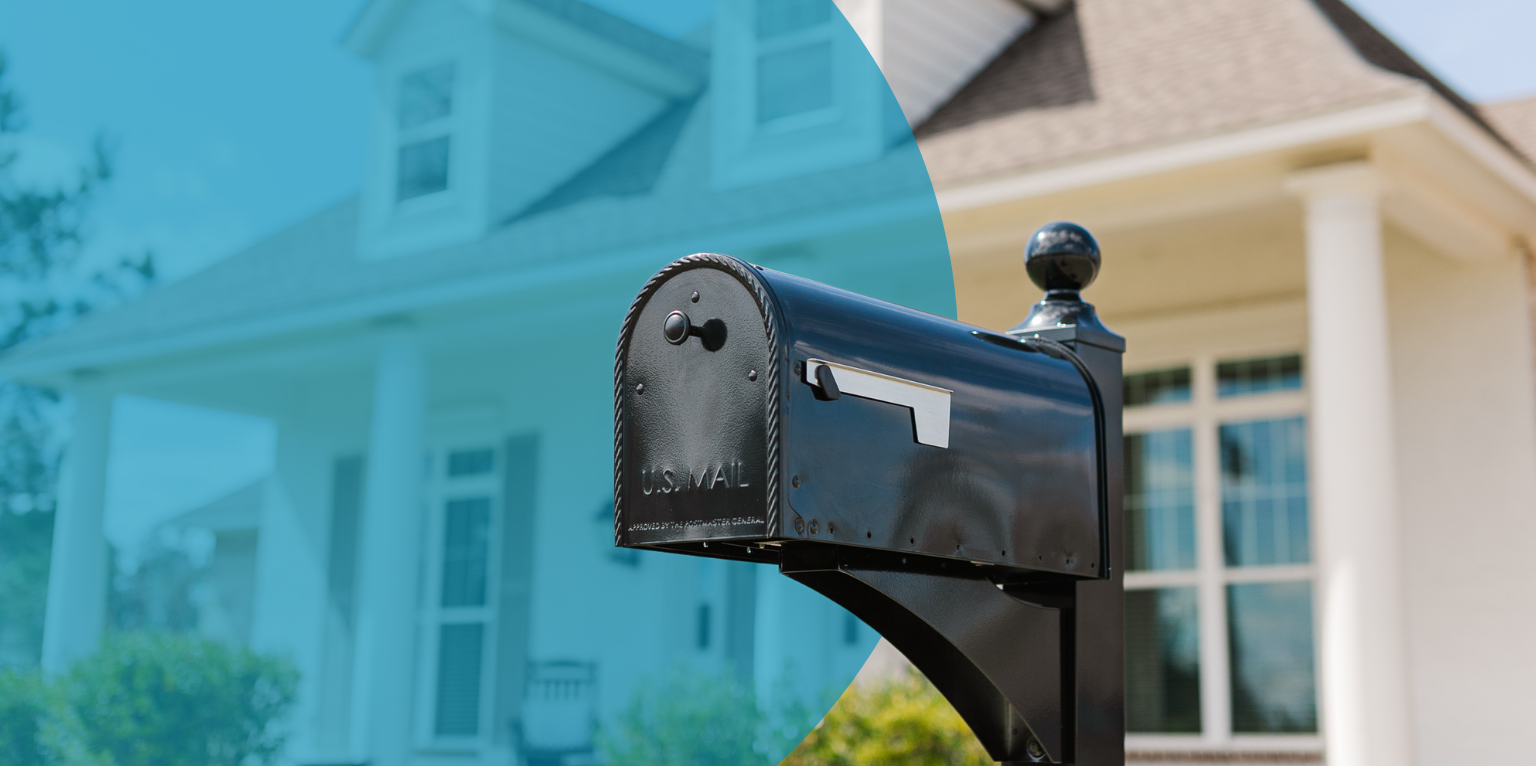Black U.S. mailbox on its post in front of a suburban house with a curved blue overlay in the foreground.